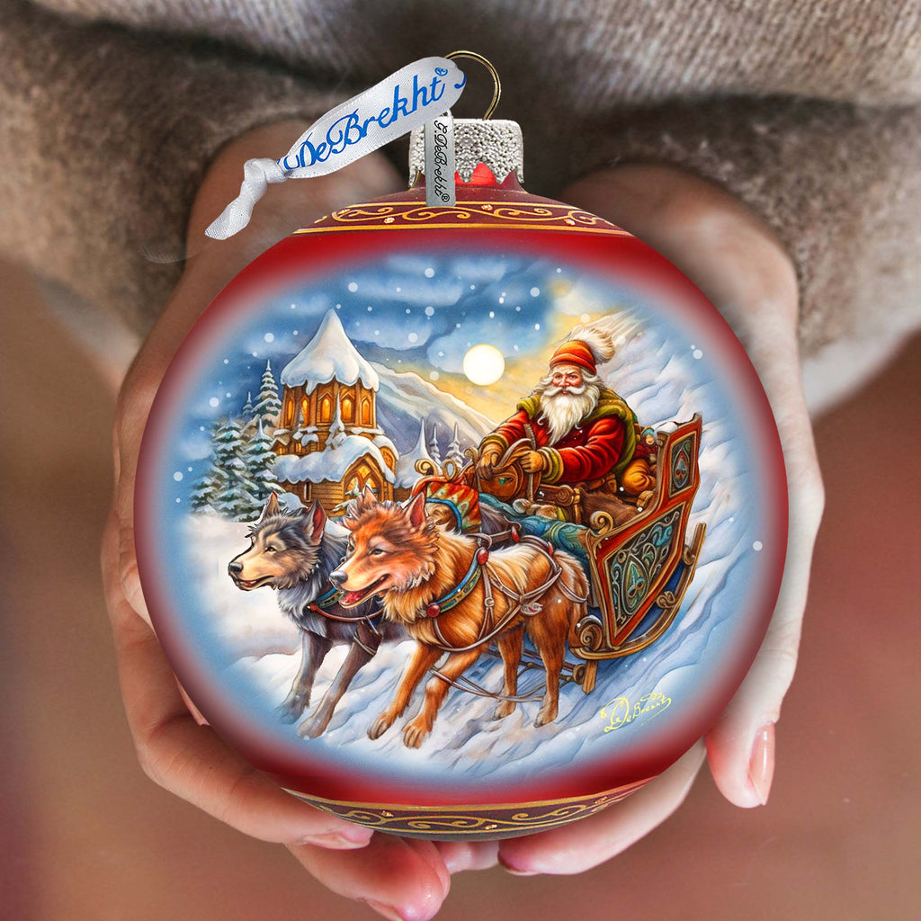 a person holding a christmas ornament in their hands