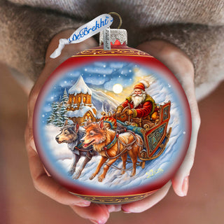 a person holding a christmas ornament in their hands