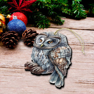 an owl ornament sitting on a table next to christmas decorations