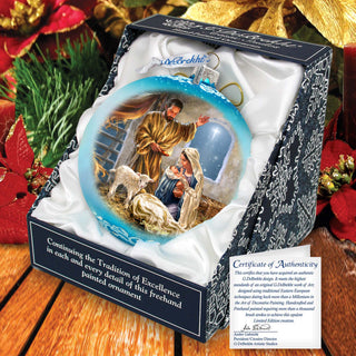 a christmas ornament with a picture of jesus and baby jesus