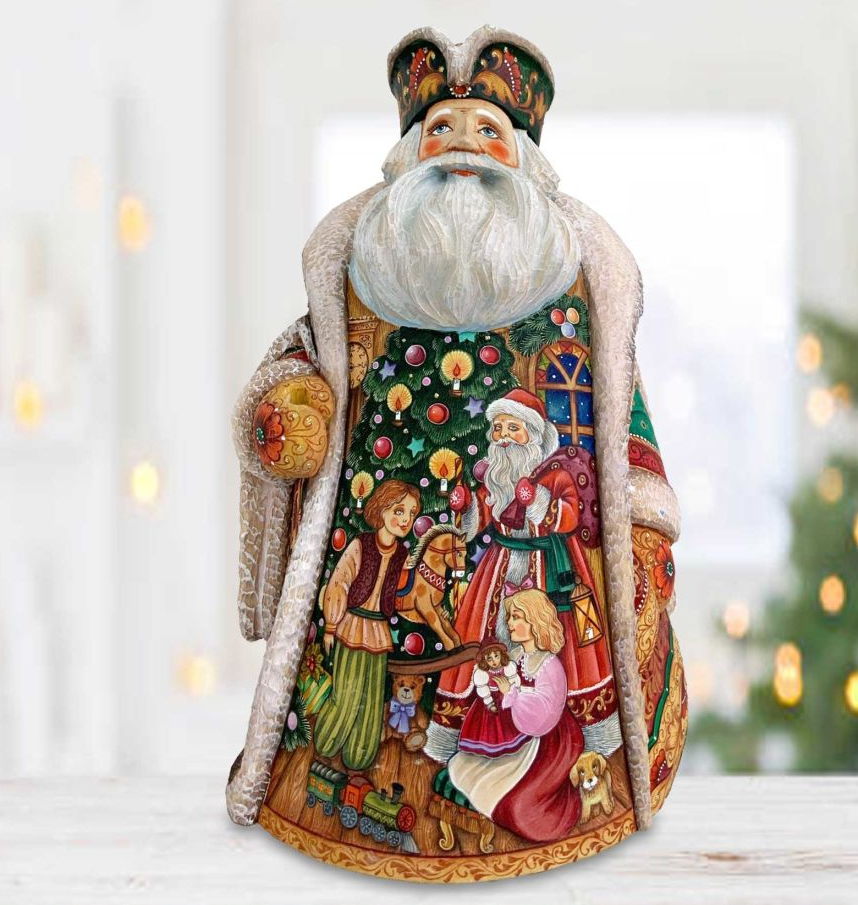 A detailed and colorful figurine of Santa Claus, with intricate patterns and designs, is displayed on a table.