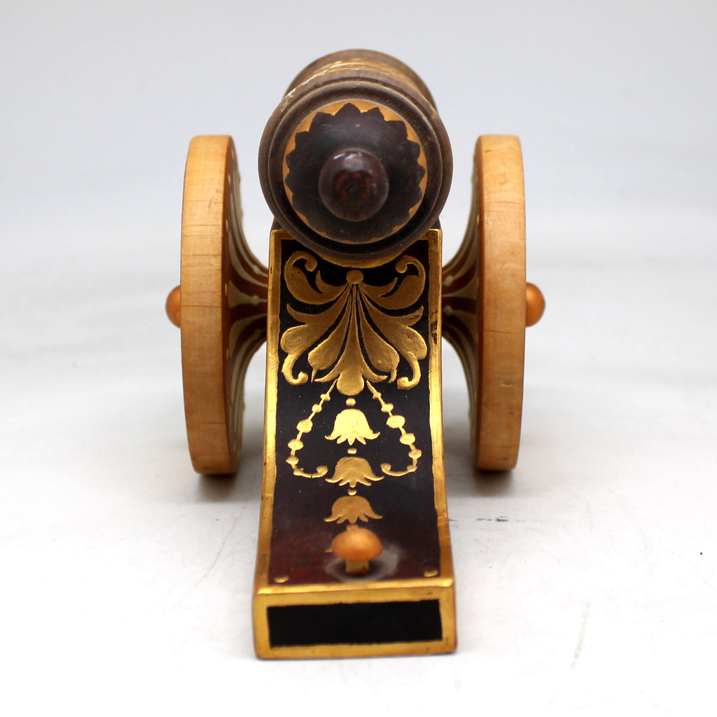 a small wooden toy car with a wooden wheel