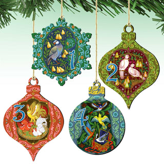 four ornate Christmas ornaments hanging from strings, each with a unique design and color scheme.