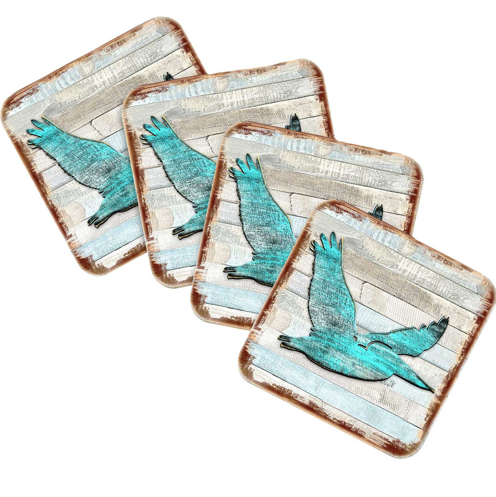 four square coasters with a blue bird design on them.