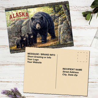 a postcard with a painting of a bear and its cubs, along with some text and a blank space for a recipient's name and address.