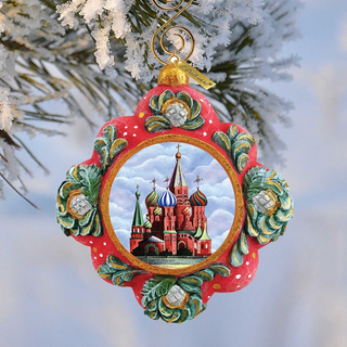 A decorative ornament featuring a painting of St. Basil's Cathedral in Moscow, Russia, hanging from a tree branch.