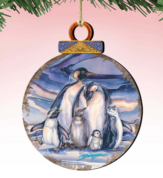 A round ornament featuring a group of penguins standing together against a snowy background.