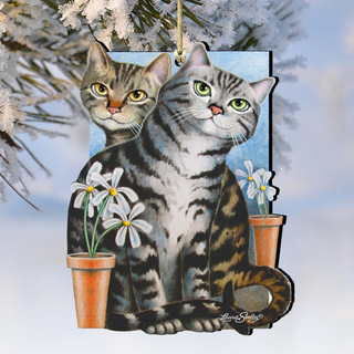 A wooden ornament featuring two cats sitting next to each other, with white flowers in orange pots on either side of them.