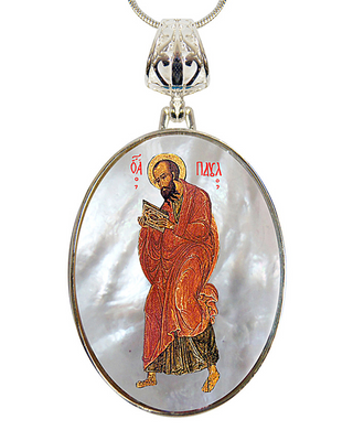 a pendant with a religious icon of a saint, possibly a Christian figure, wearing a red robe and holding a book.