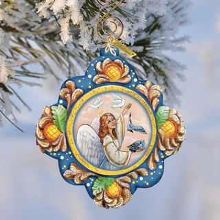 A decorative ornament featuring an angel with wings and a halo, surrounded by flowers and birds, hanging from a branch with snow on it.