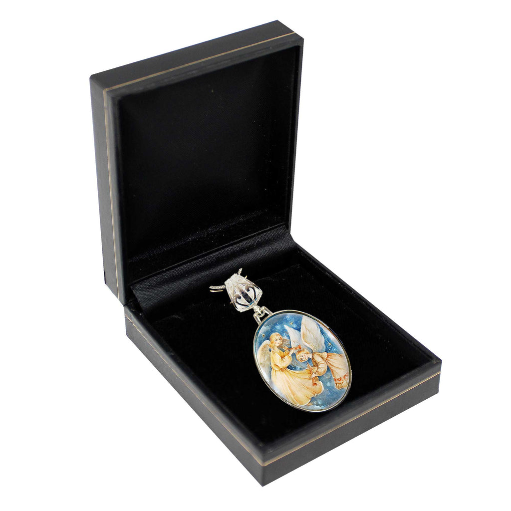 A pendant with a floral design is displayed in a black jewelry box.