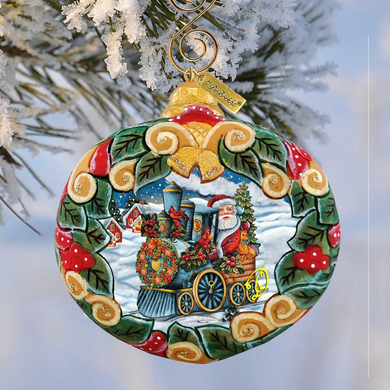 A decorative Christmas ornament featuring a Santa Claus train with a wreath of flowers and berries, set against a snowy background.