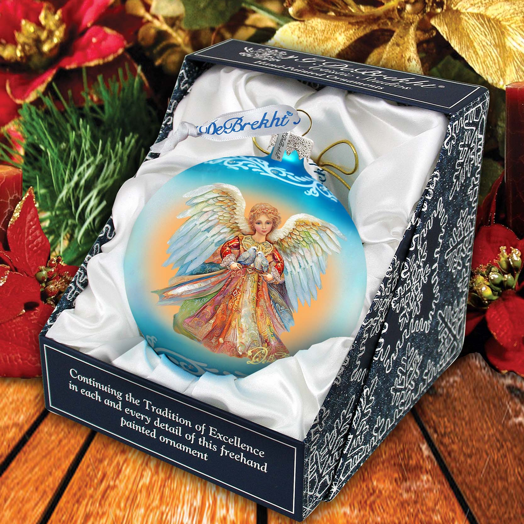 A blue and gold angel ornament in a box, surrounded by holiday decorations such as poinsettias and pine branches.