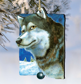 A wooden ornament depicting a wolf's head, with a snowy landscape in the background.