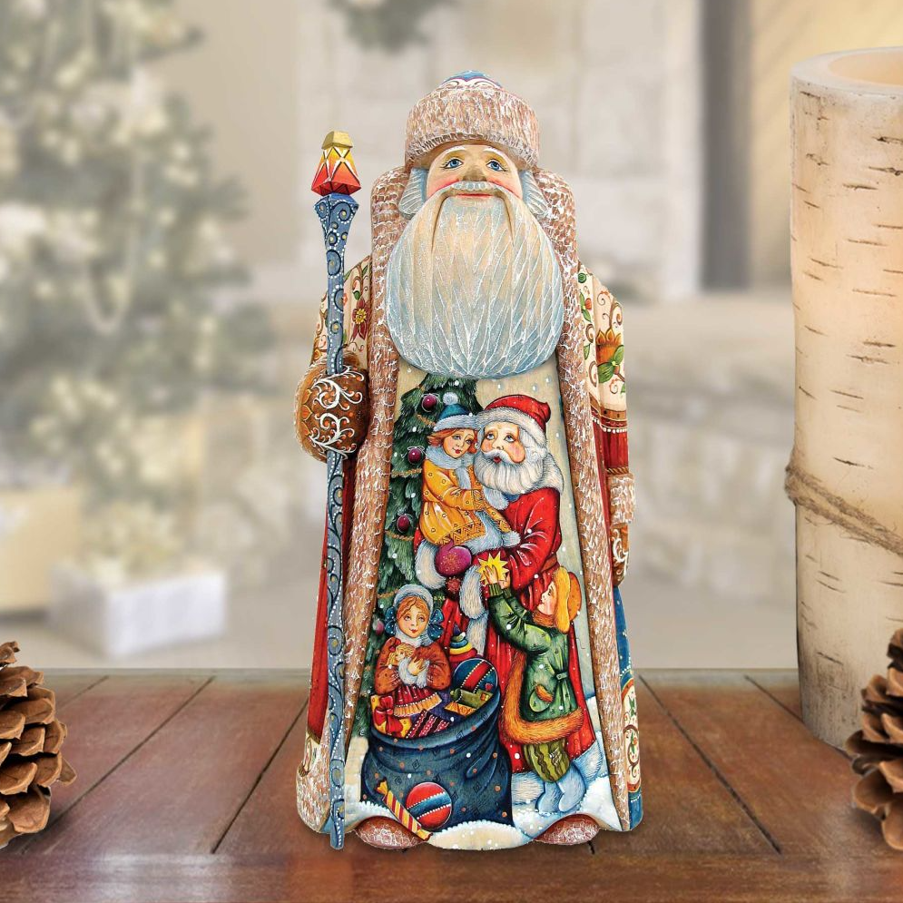 A hand-carved wooden Santa Claus figurine with a colorful, detailed design, standing on a wooden surface.