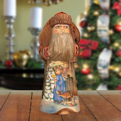 A wooden Santa Claus figurine with a long beard and a blue outfit, standing on a wooden surface.