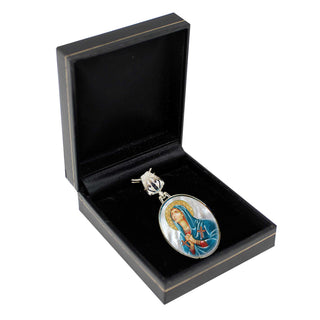A pendant with a religious icon is displayed in a black jewelry box.