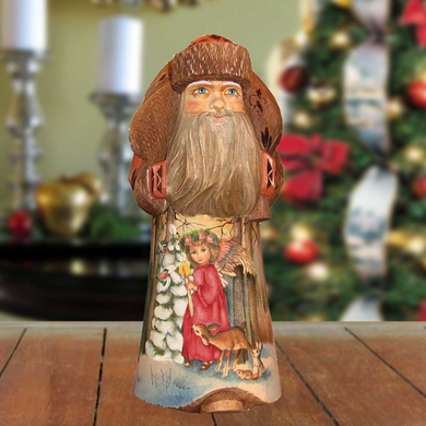 A wooden Santa Claus figurine with a long beard and a red outfit, standing on a wooden surface.