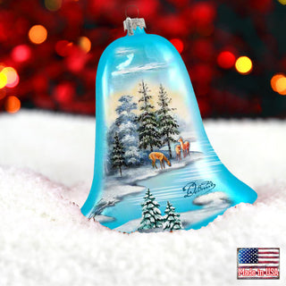 a glass bell ornament with a christmas scene on it