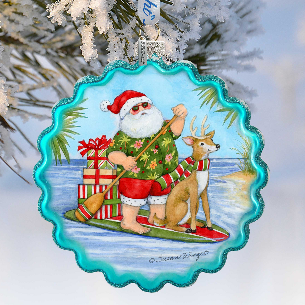 Santa Claus riding a surfboard with a reindeer and presents, wearing a green shirt and red pants, against a snowy background.