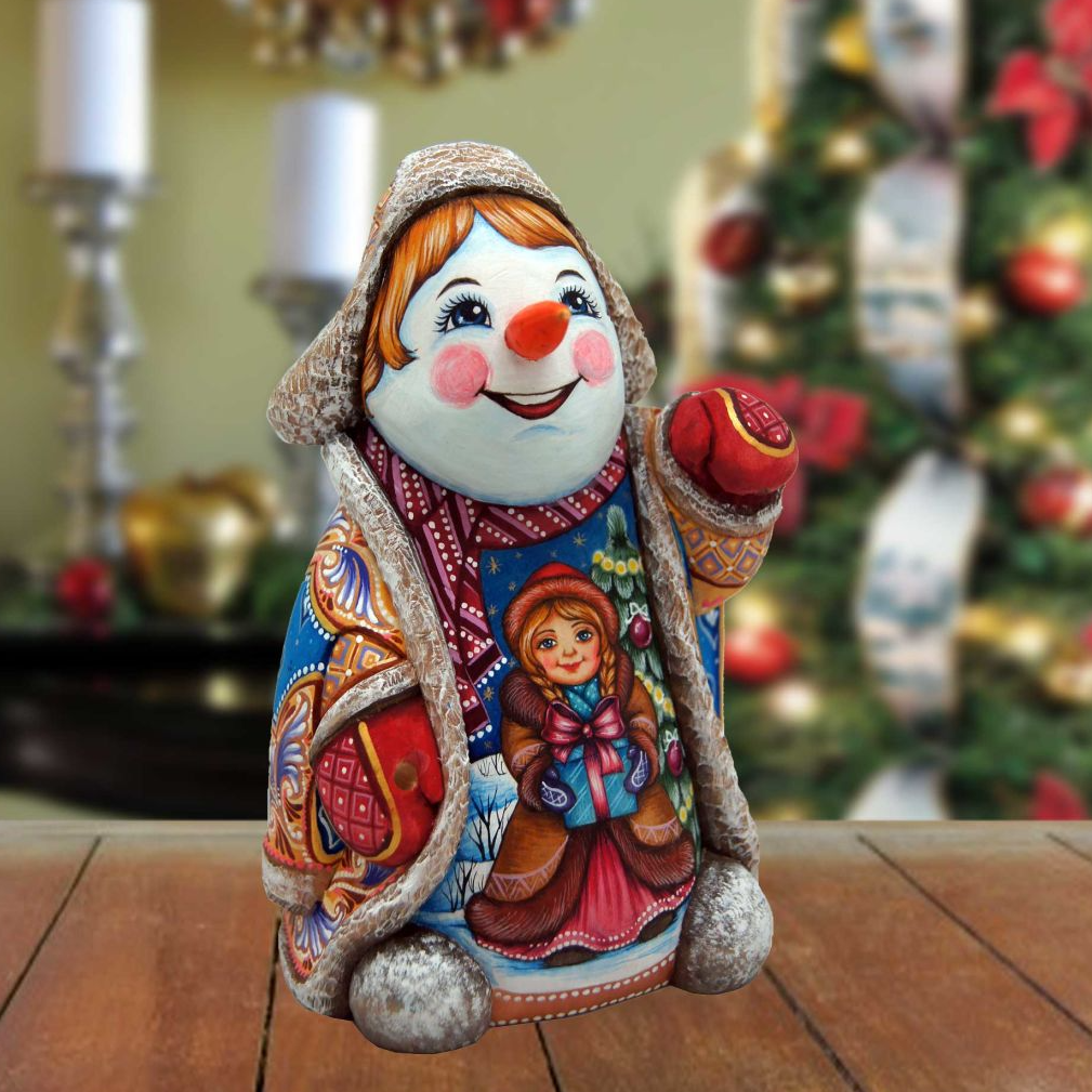 A colorful, hand-painted snowman figurine with a smiling face and a red nose, sitting on a wooden surface.