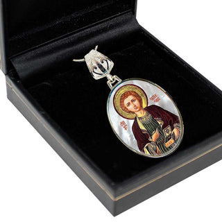 a pendant with a religious icon, placed inside a black box.