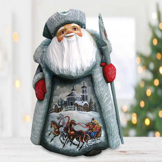 A wooden Santa Claus figurine with a painted winter scene on its belly, holding a sleigh and decorated with red and white accents.