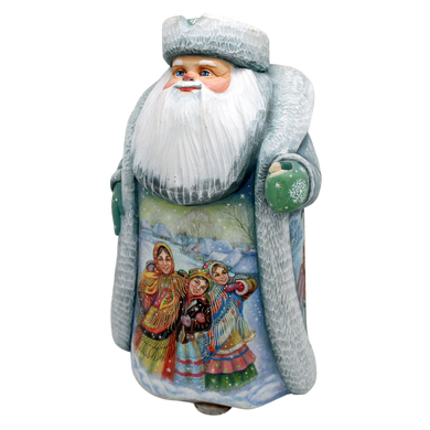 A ceramic Santa Claus figurine with a white beard and hat, wearing traditional clothing and holding a green ornament.