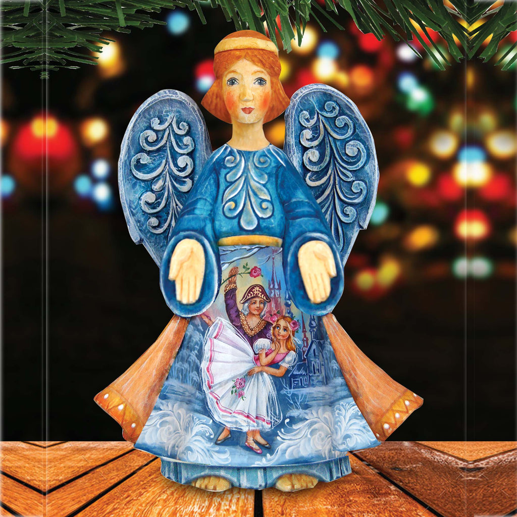 A blue and white angel figurine with intricate designs and a scene of dancing figures is displayed against a blurred background with colorful lights.