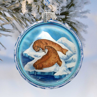 A round ornament featuring two walruses on an ice floe, with a snowy background.