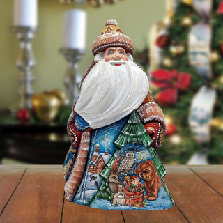 A colorful, hand-painted Christmas ornament depicting Santa Claus with various animals, including a bear, owl, and rabbit, set against a snowy landscape.