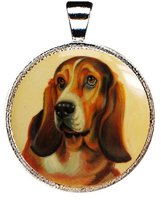 A pendant featuring a close-up portrait of a basset hound dog.