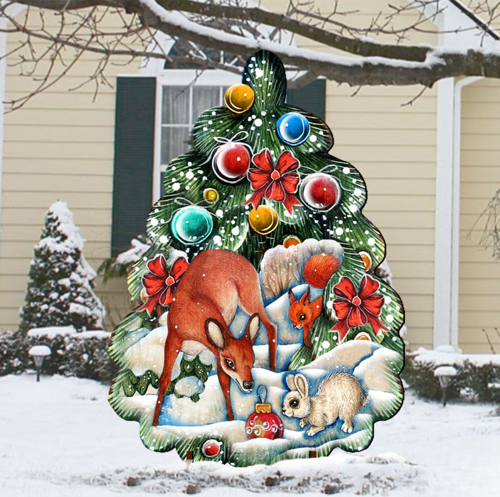 A large, colorful Christmas tree ornament featuring a deer, rabbit, and other woodland animals, surrounded by snow and decorated with ornaments and lights.