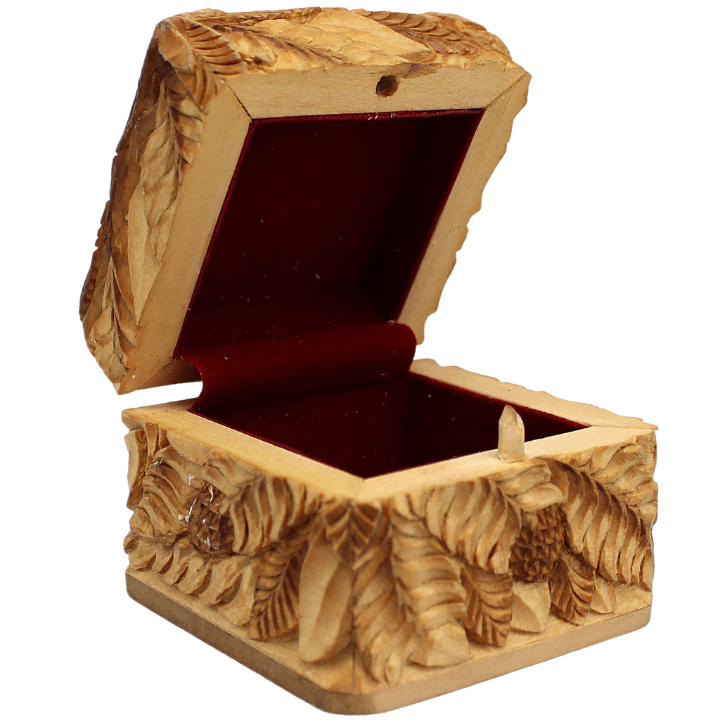 An intricately carved wooden box with a red interior, featuring detailed patterns and designs.
