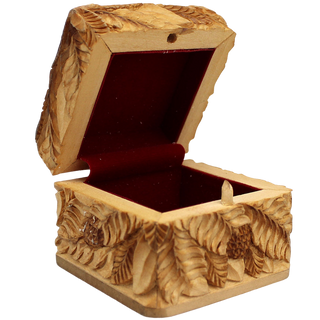 An intricately carved wooden box with a red interior, featuring detailed patterns and designs.