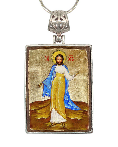a religious icon of Jesus Christ, with a halo and a blue robe, set against a golden background.