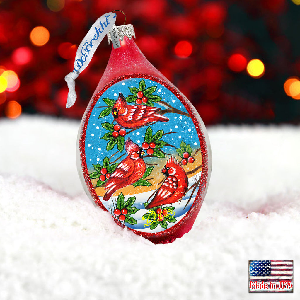 a christmas ornament with a red bird on it