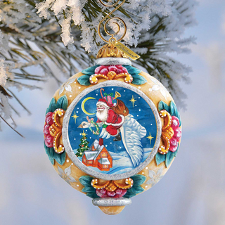A colorful Christmas ornament featuring a Santa Claus figure, a snowy landscape, and a starry night sky.
