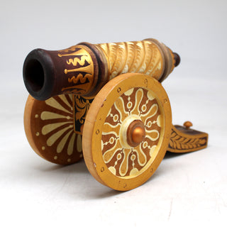 a close up of a toy cannon on a white surface