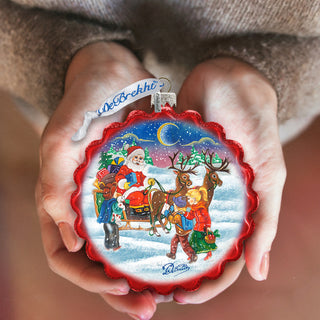 a person holding a christmas ornament in their hands