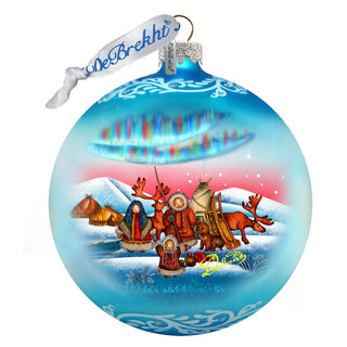 a glass ornament with a christmas scene on it