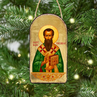 a religious icon of Saint Basil, a saint from the Orthodox Christian tradition, hanging on a Christmas tree.