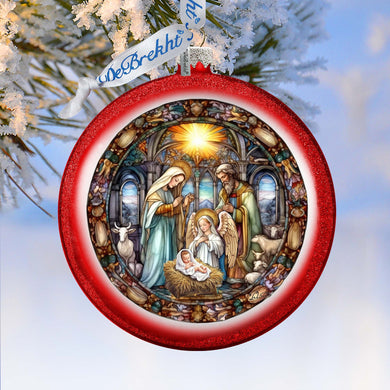 A red ornament with a detailed illustration of the nativity scene, featuring the baby Jesus, Mary, and Joseph in a church setting.
