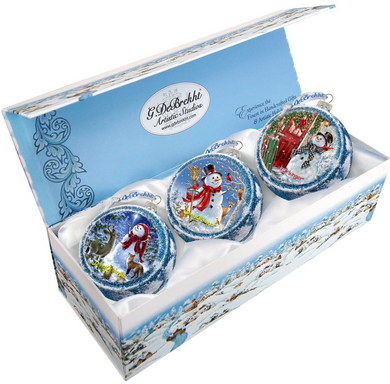 A set of three decorative Christmas ornaments in a blue box, each featuring a different winter scene.