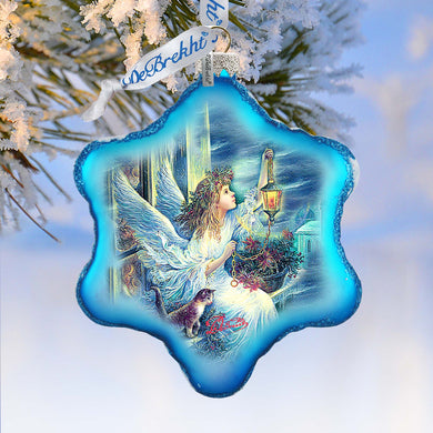 A blue star-shaped ornament with a painting of a winged figure and a cat inside, hanging on a snowy branch.