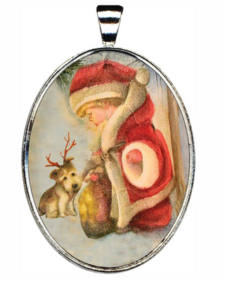 A pendant featuring a painting of a young girl in a red Santa Claus outfit, with a small dog wearing antlers on her head.