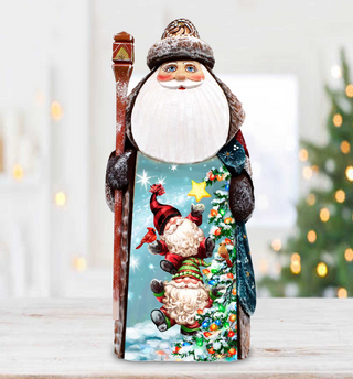 A wooden Santa Claus figurine holding a star and a gnome, set against a blurred background with Christmas lights visible.