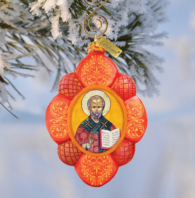 A decorative ornament featuring a religious icon of St. Peter, hanging on a tree branch.
