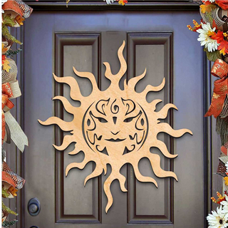 a wooden sun decoration hanging on a door.