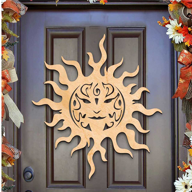 a wooden sun decoration hanging on a door.